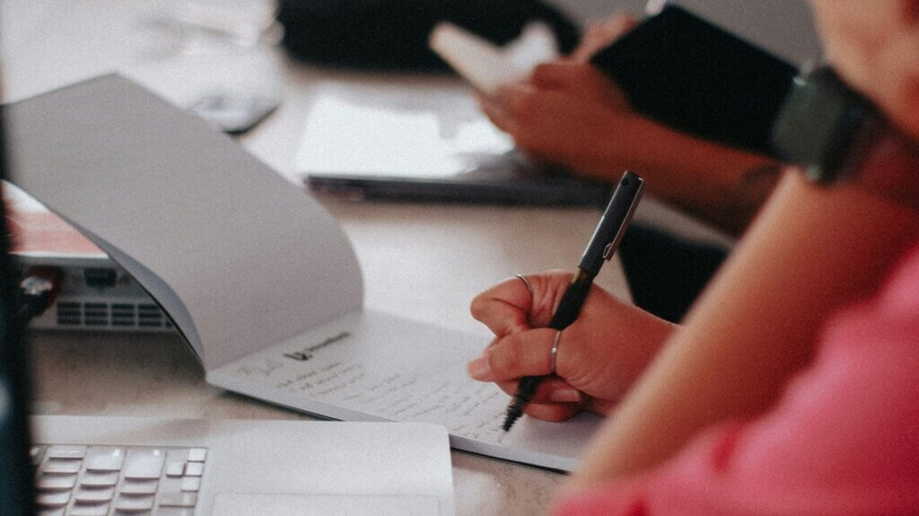 a person writing in a notepad