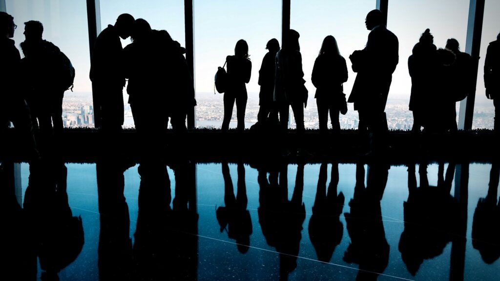 A group of people in front of a window